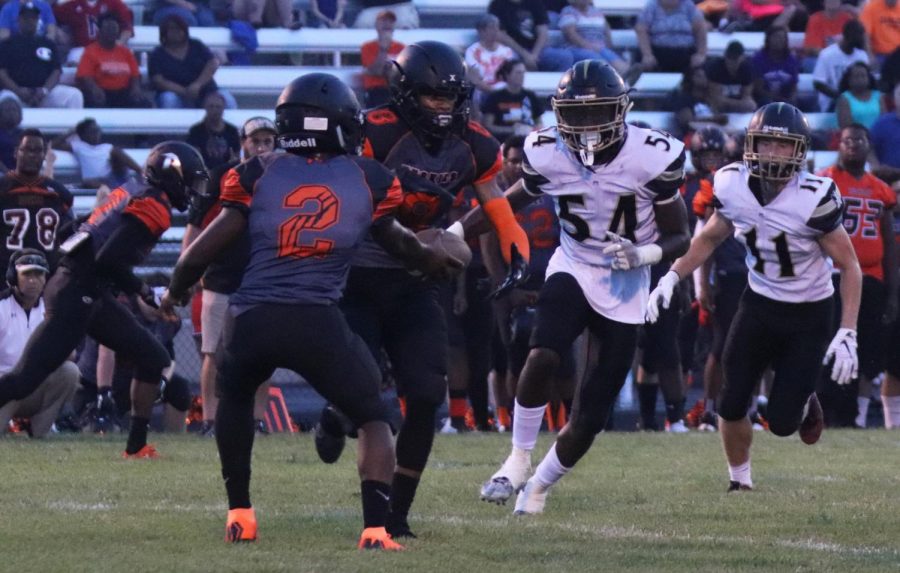 Senior Joshua Simmons, number 54, runs towards the running back and attempts to tackle him. Simmons is the starting linebacker for FHN's Varsity Football team.