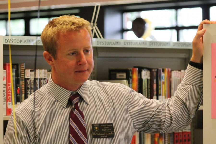 Head Principal Nathan Hostetler looks on while students pick up their schedules on July 30.