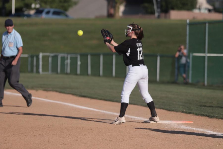 Sophomore Audrey Sevier catches the ball at first base to get the runner out in a game against FHHS