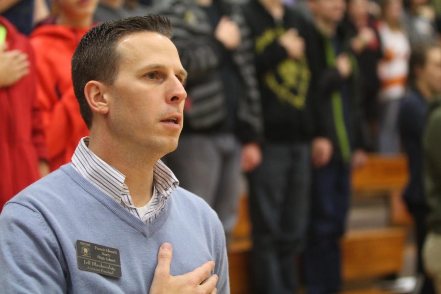 Assistant Principal and veteran Jeff Blankenship pauses to pledge allegiance to the American flag.