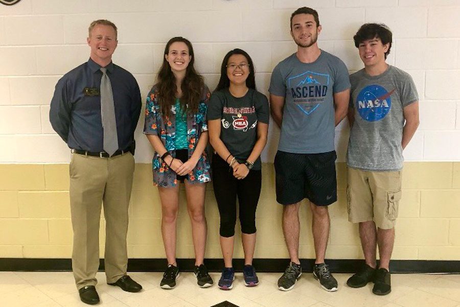 Principal Nathan Hostetler stands with four seniors who were named National Merit Semifinalists. [From left to right] Seniors Madeline DeGraw, Arianna Chaves, Blake Peters and Riley Lawson were all named National Merit Semifinalists.