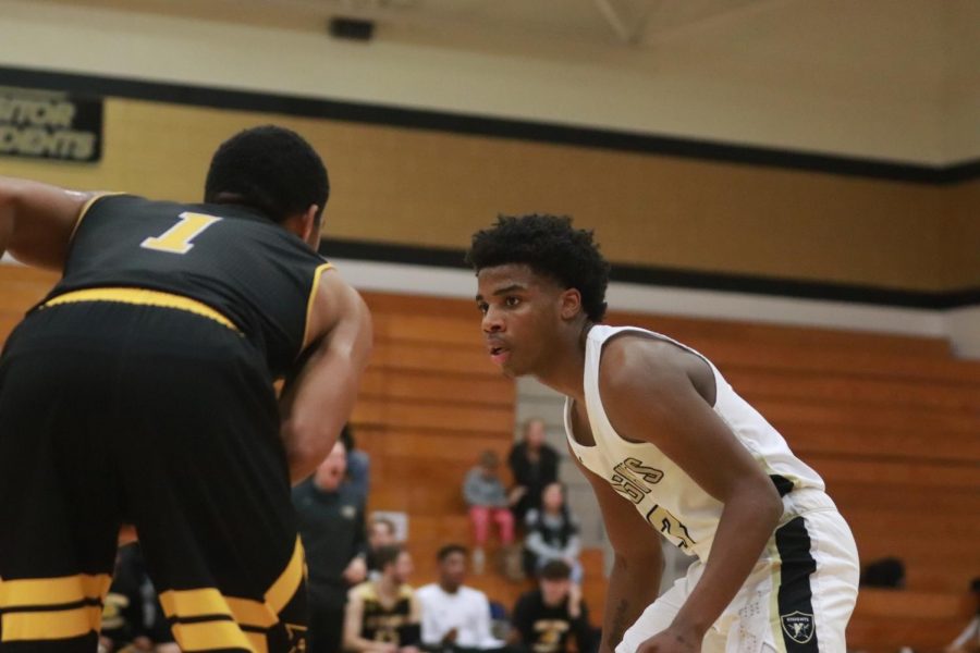 Freshman Dontrell Woods guards a player from FZE in their game on 12/18.