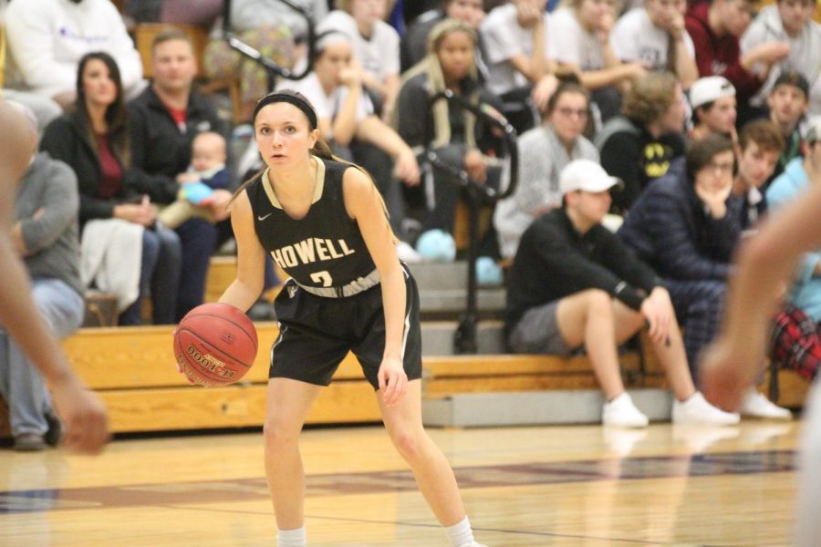 Senior Mackenzie Pugh dribbles the ball the ball in a game against FHC.