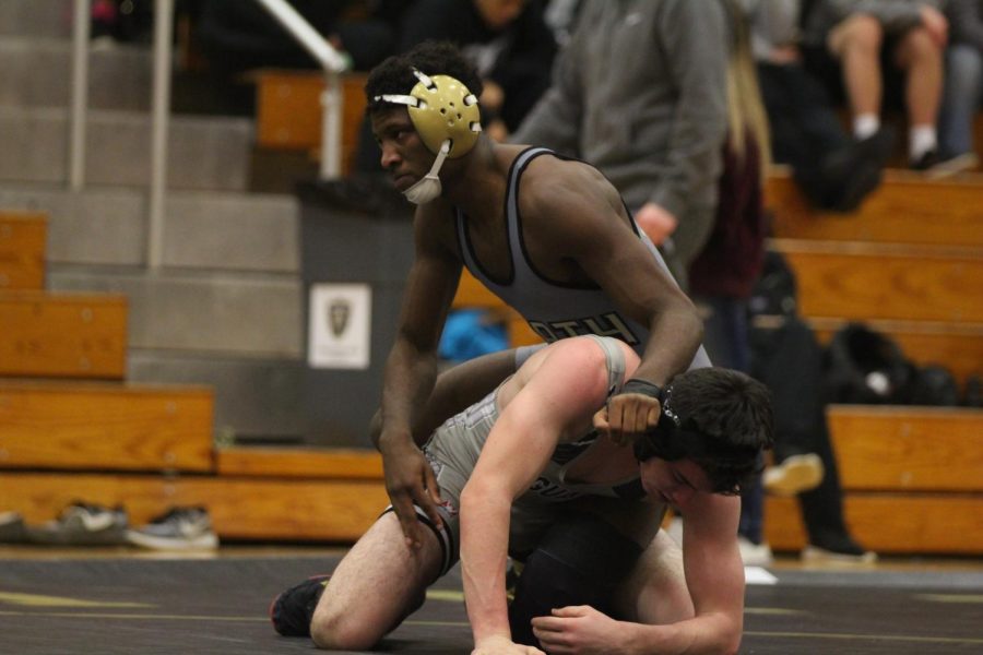 Senior Josh Simmons takes down his opponent and attempts to pin him in a match against FZW on January 15. Simmons is one of the nine seniors on the team.