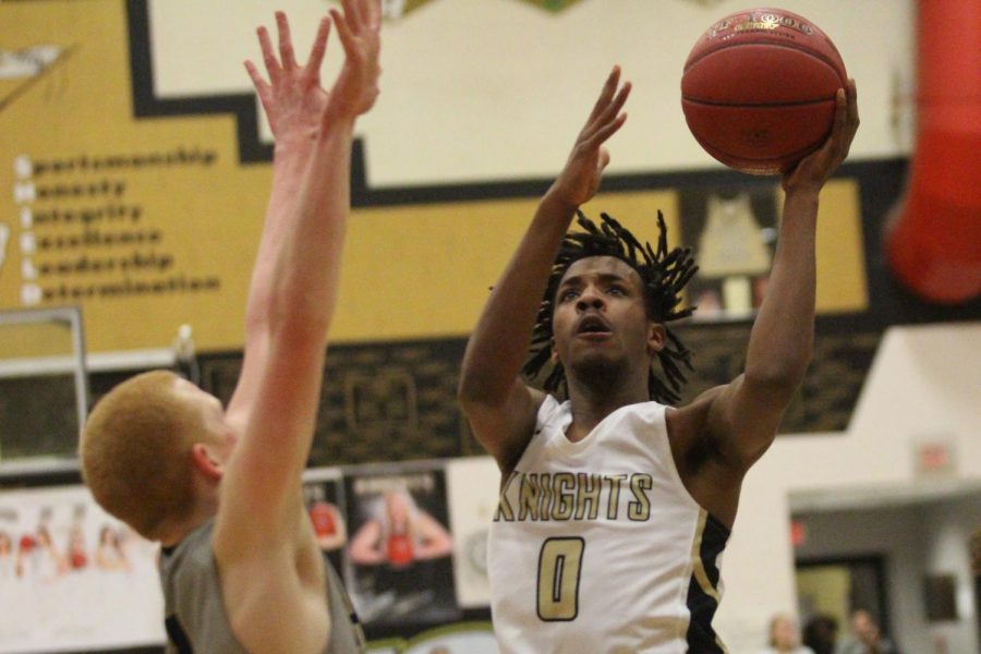 Senior Miles Montgomery goes up for a layup against Holt