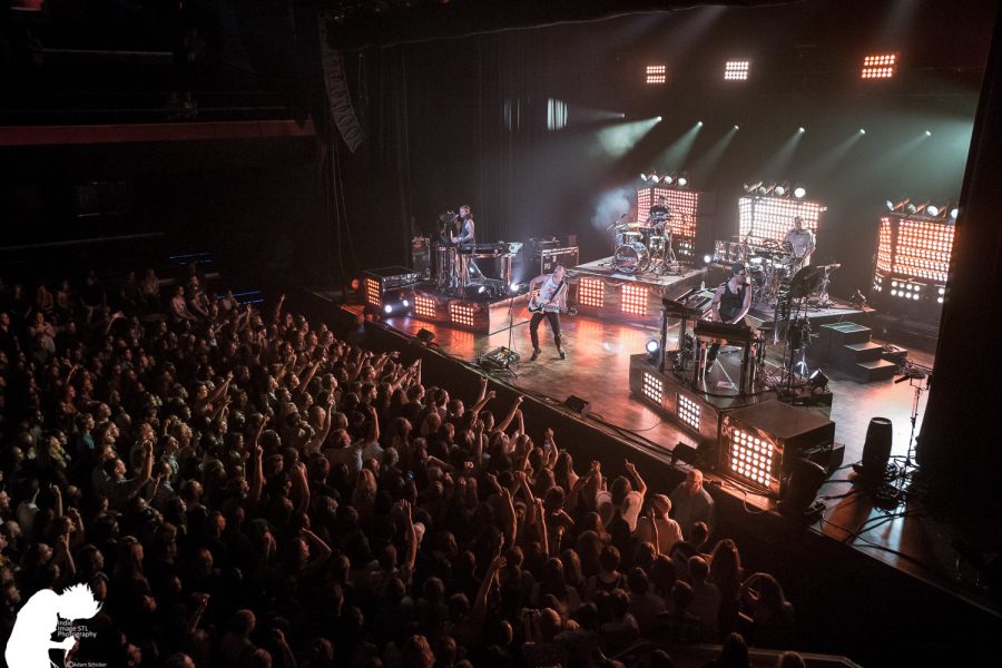 The crowd of people storm to the front with hands raised as the drummer performs. The Pageant has hosted many bands and singers from all over. This concert had high intensity and made the crowd of people go crazy.