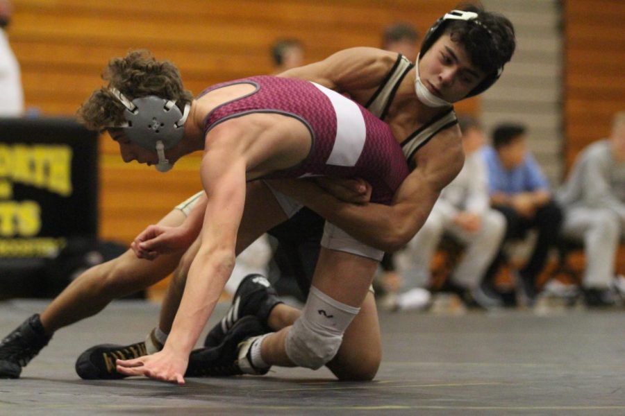 Sophomore Corbin Shabany takes down opponent in a match against St. Charles West in a tri duel. The Warriors would get the close win over the Knights by a score of 45-39