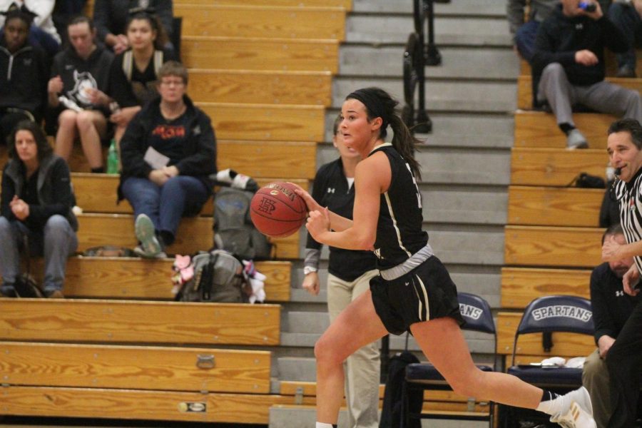 Senior Gabby Delarue dribbles the ball down the sidelines in a game against FHC