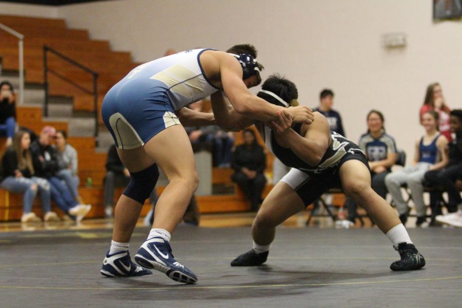 Senior Thadeus Meneses grasps his opponent in a duel against Holt