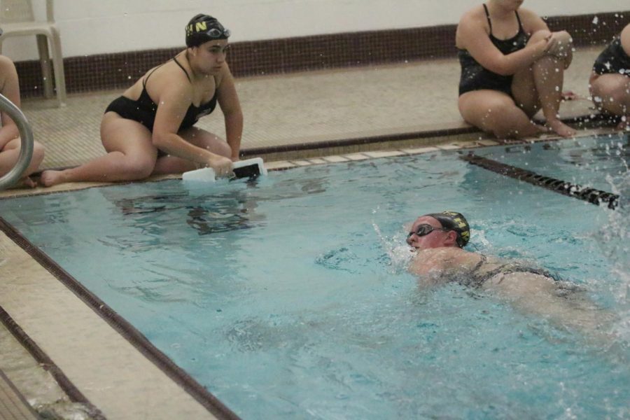 Freshman Ana Sofia cheers on fellow teammate Grace Bigogno as she completes her 500 yard event on Jan. 9.