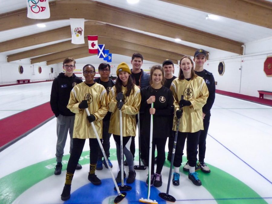 The curling team poses for a picture in Exmoor Country Club in Chicago during their trip in late December. The curling team has existed for two ears and placed third in lat year's regional tournament.