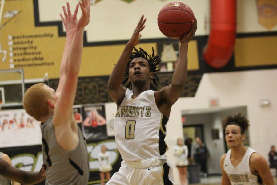 Senior Miles Montgomery drives to the basket to make a layup.