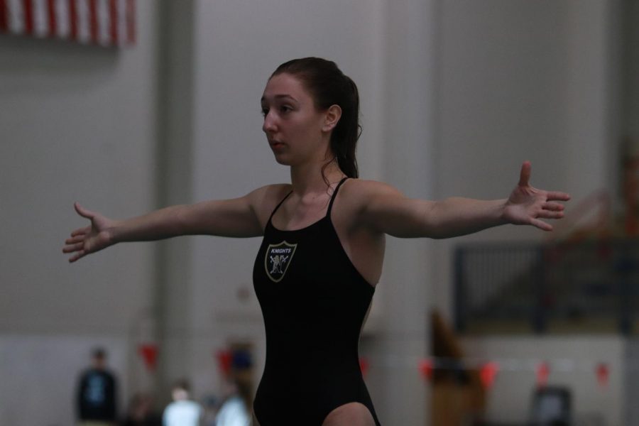 Senior Kamryn Bell prepares to dive into the water.