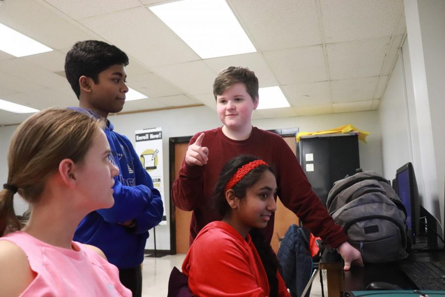 Freshman Evan Becker talks about the upcoming
speech and debate districts with fellow members Carly Gordon, Pavan Kolluru and Amoolya Pandurangi.