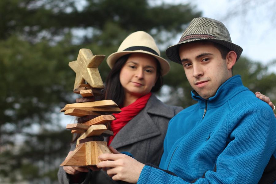 Holding a tiny tree made from the scraps of trees left from Hurricane Maria, sophomore Andres Cancel and his mother, Damaris Nadal Colon, sit and remember the tragedy of the traumatic hurricane. The family healed from the hurricane and sent the tiny tee to Andres when the tragedy was over.