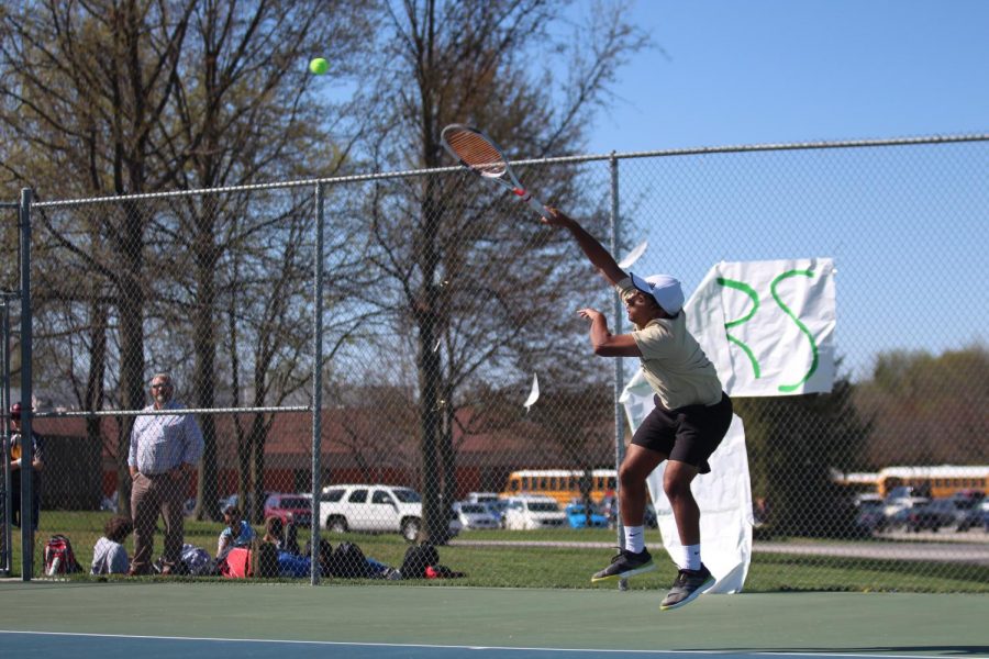 Sachin Milli unloads on the ball after his serve.