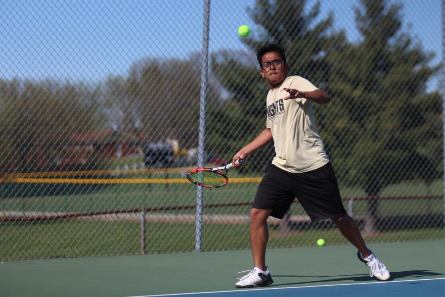 Senior Kanish Patel attempts to het the ball back over the net.