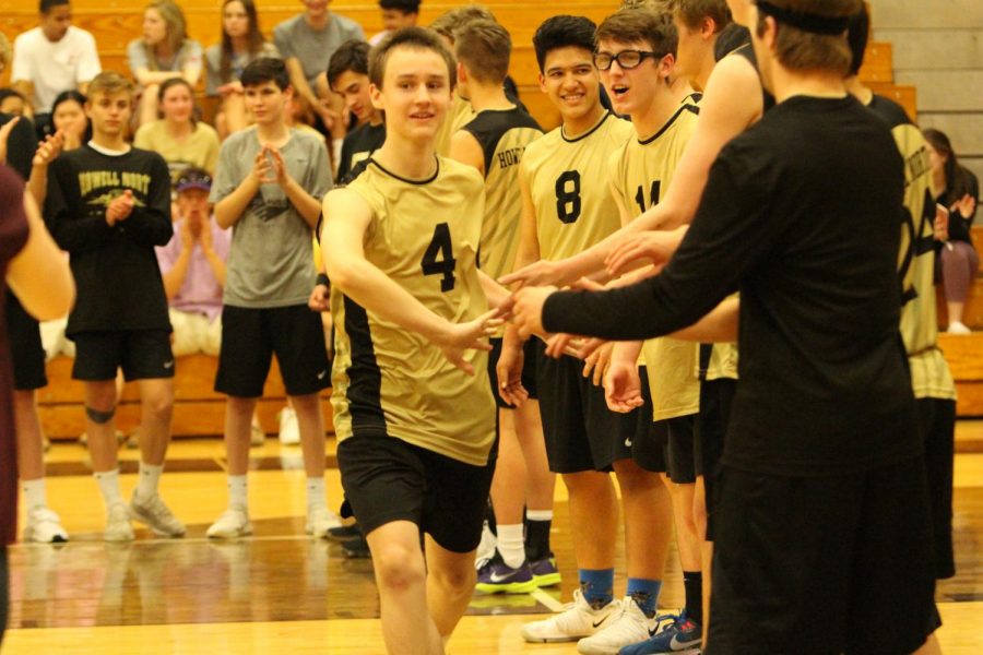 Freshman Zach Zimmerman runs down the line to get high fives from all his teammates before the game against De Smet.