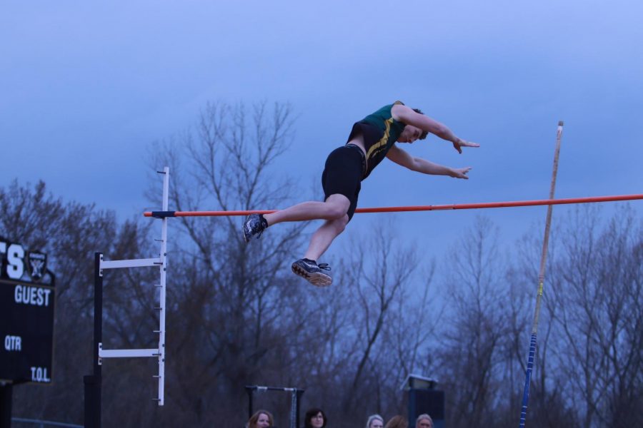 FHN pole vaulter leaps over the bar in a competition.