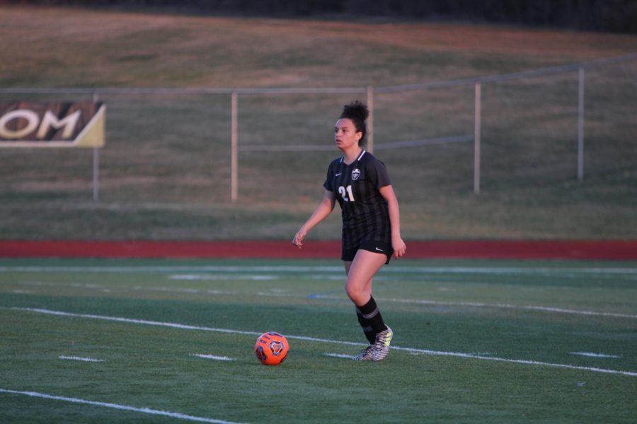 Freshman Makenna Davis dribbles up the field during a game. Davis, along with Jessica Gillen, have been starters on the varsity team since the beginning of the year.