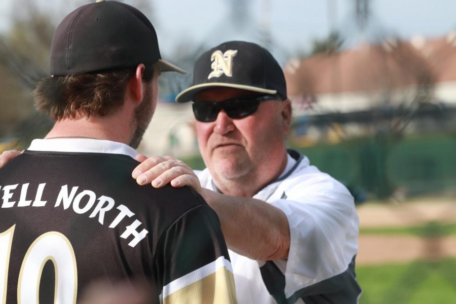 Head coach Bob Donahue talks to junior Adam Lange during game against Troy Buchanan.