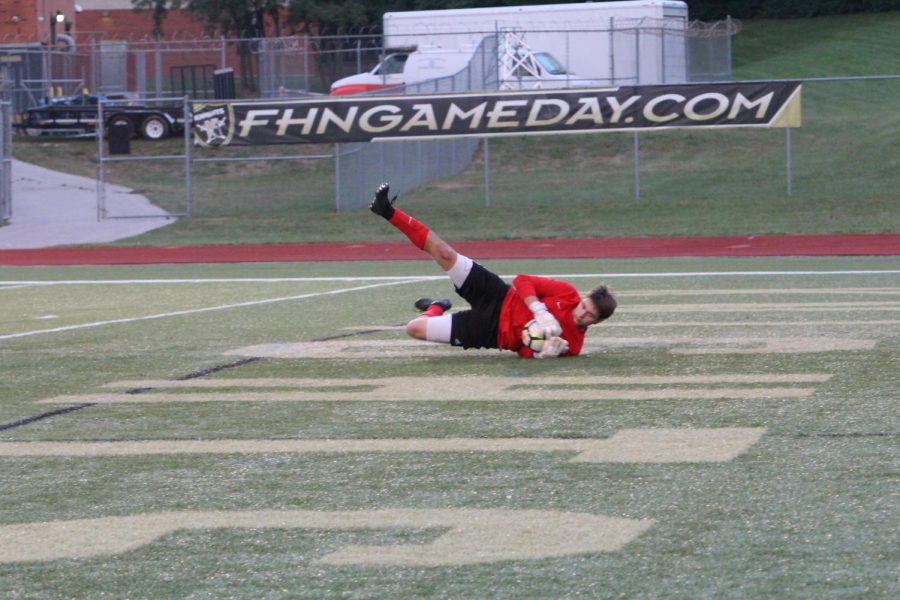 Senior Corey Valleroy makes a diving save, preventing a goal in a game against FHHS