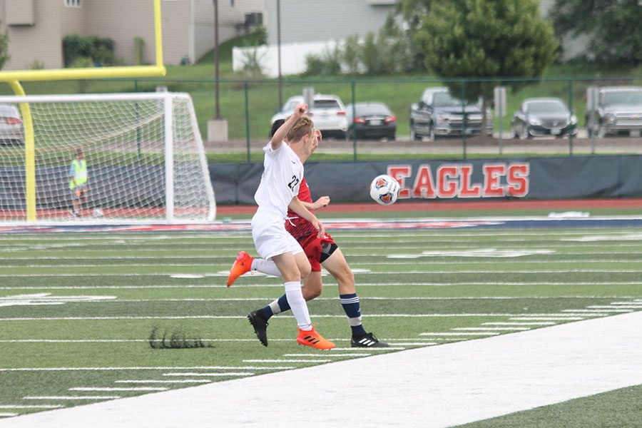 Jackson Houk works to get the ball away from a Liberty player at the game on Aug. 31, 2018. Photo by Phoebe Primeau