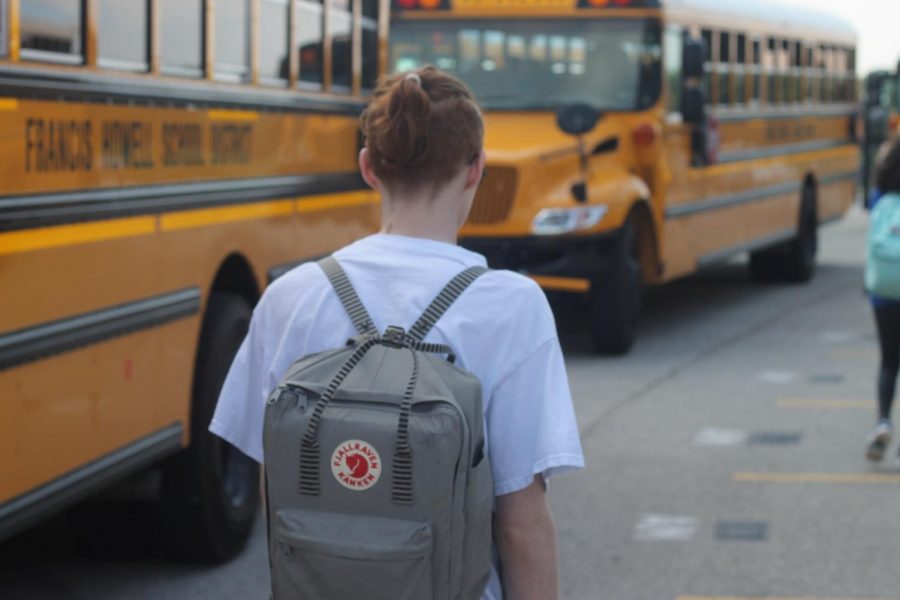 After school junior Brandon Bridgeman walks to his bus to go home. Starting in the 2020-21 school year, school will not be able to start until two weeks before the first Monday in September. “There’s so many things to consider in the calendar,” Lisa Simpkins, co-chair of the Calendar Committee, said. “There’s so many different perspectives and different ways to manipulate the calendar [that] affect different people in different ways.” (Photo by Sam Watkins)