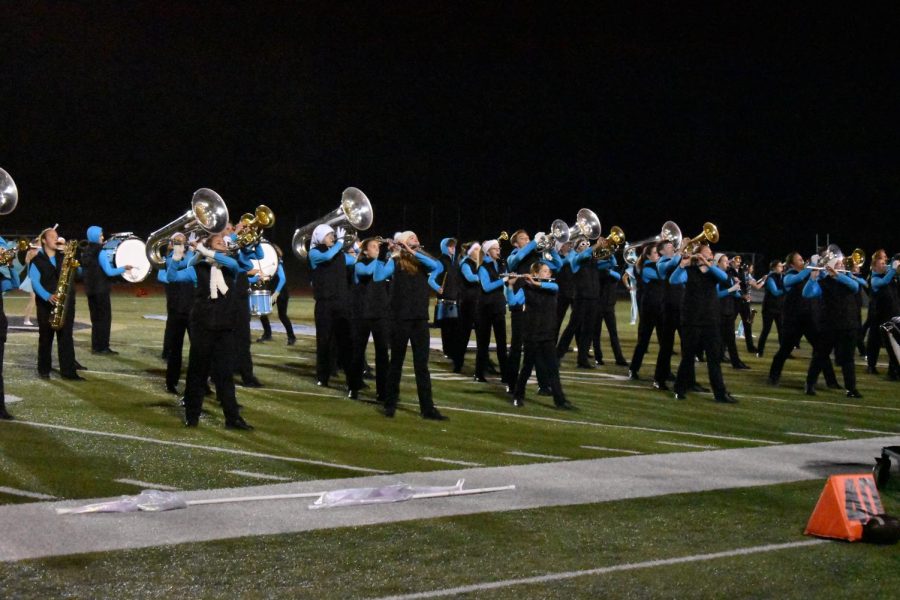 Senior Emma Temper and freshman Emma Landwehr passionately play their flutes in a performance of Freeze, the FHN’s marching band set. The marching band played at every home football game and performed at competitions. The band qualified for finals in the Sullivan Marching Festival. (Photo by Courtney Wortman)