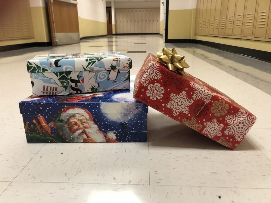 Junior and Senior NHS members work to collect holiday boxes for Samaritan's Purse. Students had the opportunity to put together a box consisting of clothes,  necessities and toys for families in need. (Photo by Allison Cavato)