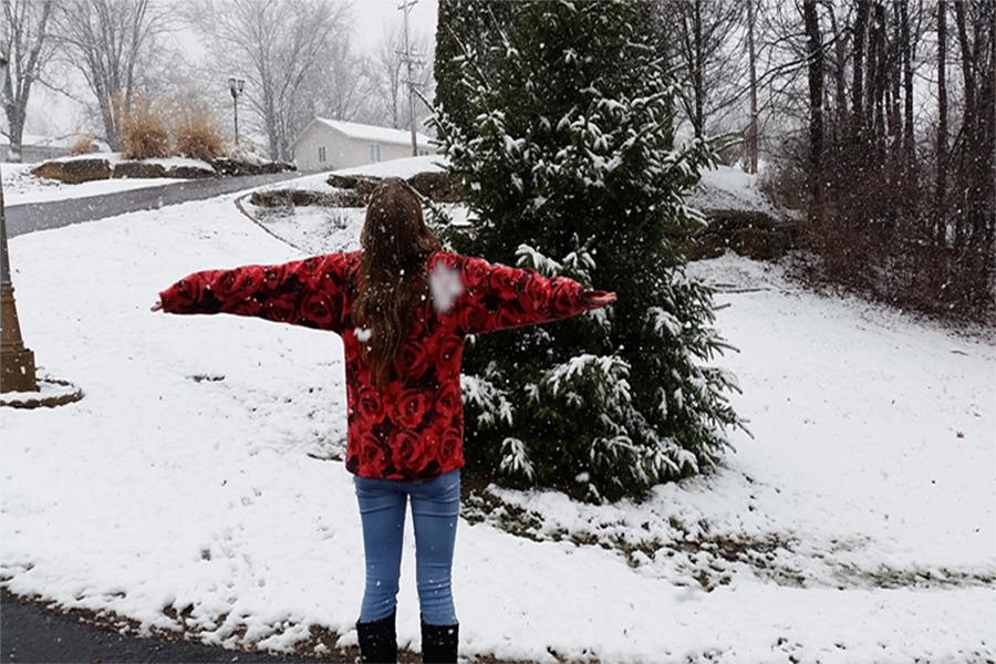 Junior Chloe Horstman spins in a snow flurry.  She feels snow is magical and timeless.