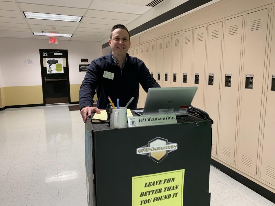 Principal Jeff Blankenship rolls his new desk down the hallway. (Photo by Macy Cronin)