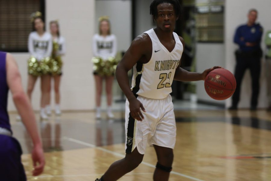 Senior Sterling Jones dribbles the ball down the court in an attempt to get a basket.
