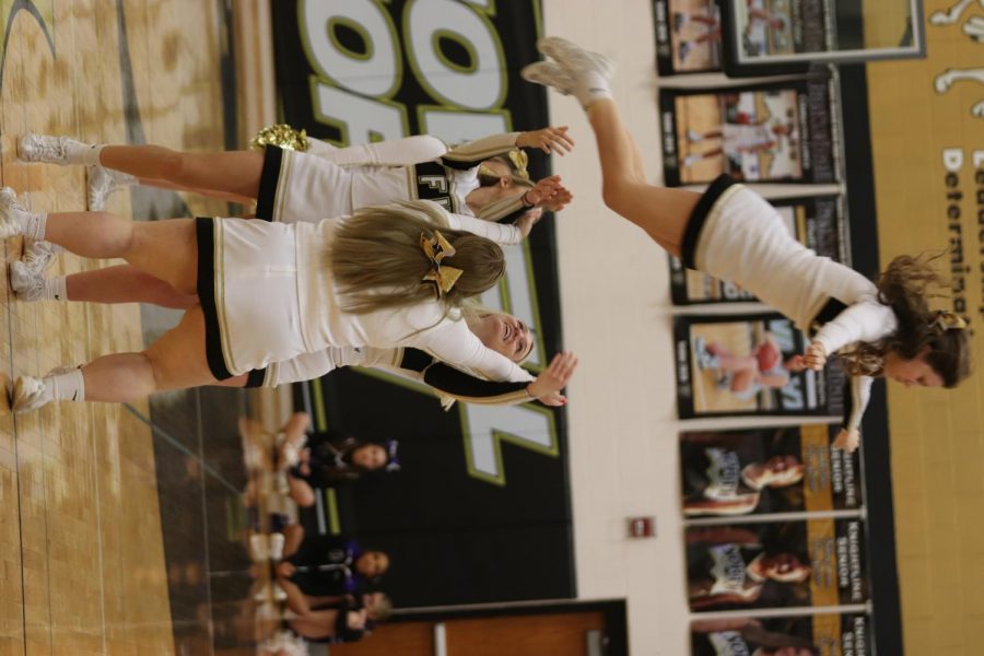 Senior Lindsey Papka is thrown into the air in the cheer performance during halftime.
