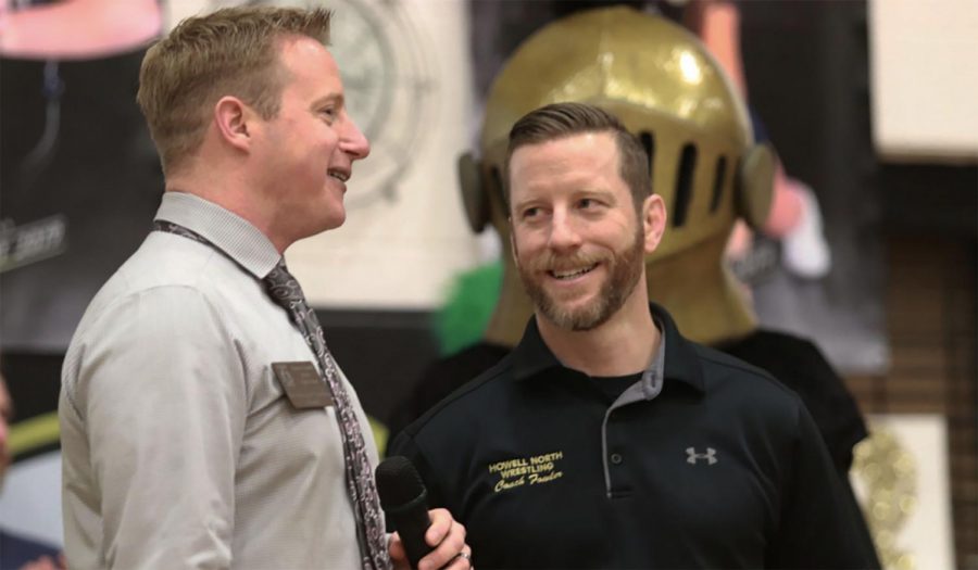 Head principal Nathanael Hostetler talks to Sean Fowler at an assembly. 