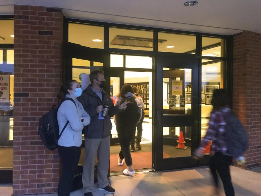 Head principal Nathanael Hostetler stands at the main door to welcome students into the school.