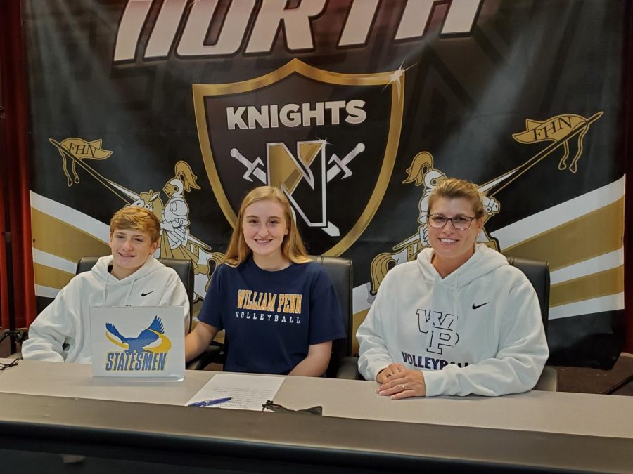 Senior Cate Hahn smiles with her family while signing to William Penn on National College Signing Day on Nov 11