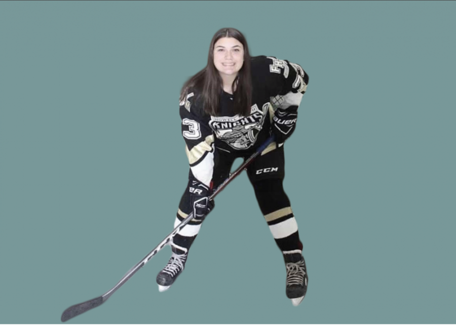 Sophomore Sarah Korte poses on the ice. HHer stick in hand and a smile on her face while wearing her Knights hockey jersey. 