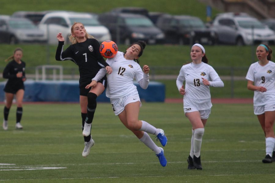 Senior Brynna Rutherford jumps in attempt to knock the ball away from her opponent.