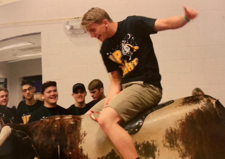 A senior rides a mechanical bull at the All-Knighter 2019. 