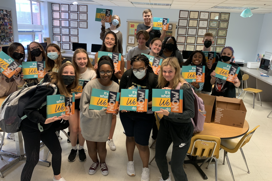 The yearbook staff poses with the 2021 yearbooks shortly after they arrive