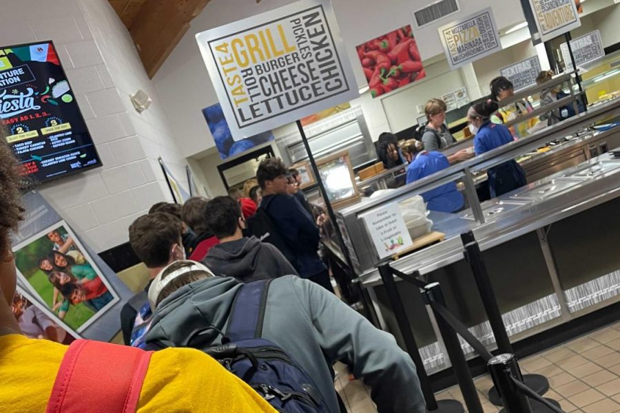 Students wait in line in the cafeteria for lunch.