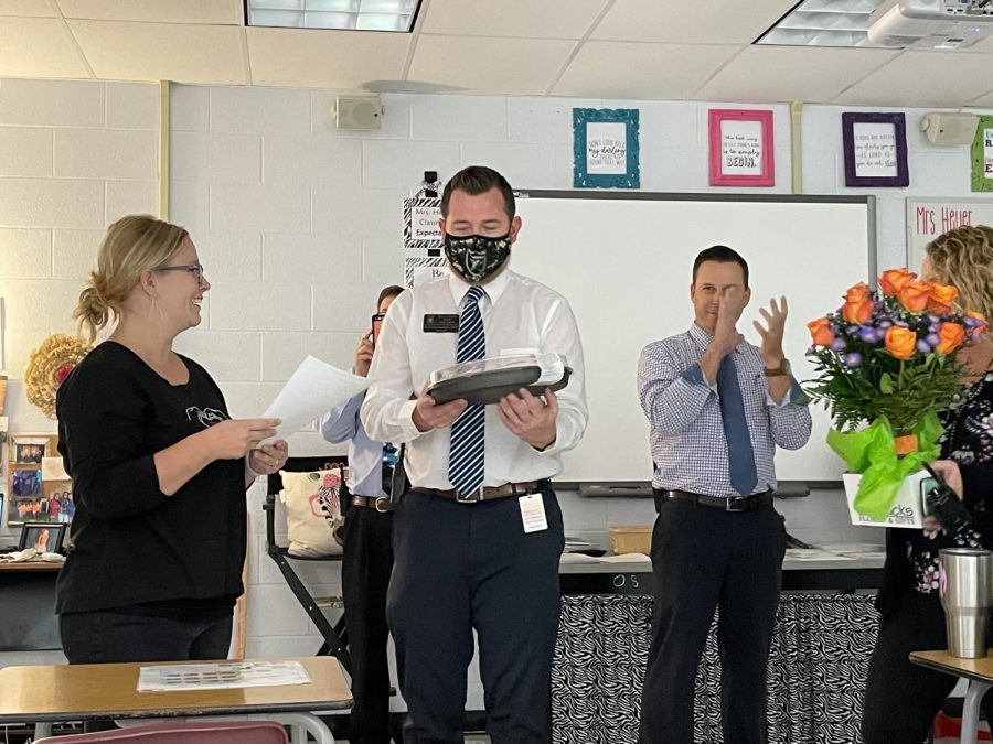 FCS teacher Marissa Heyer accepts award from Head principal Dr. Lucas Lammers