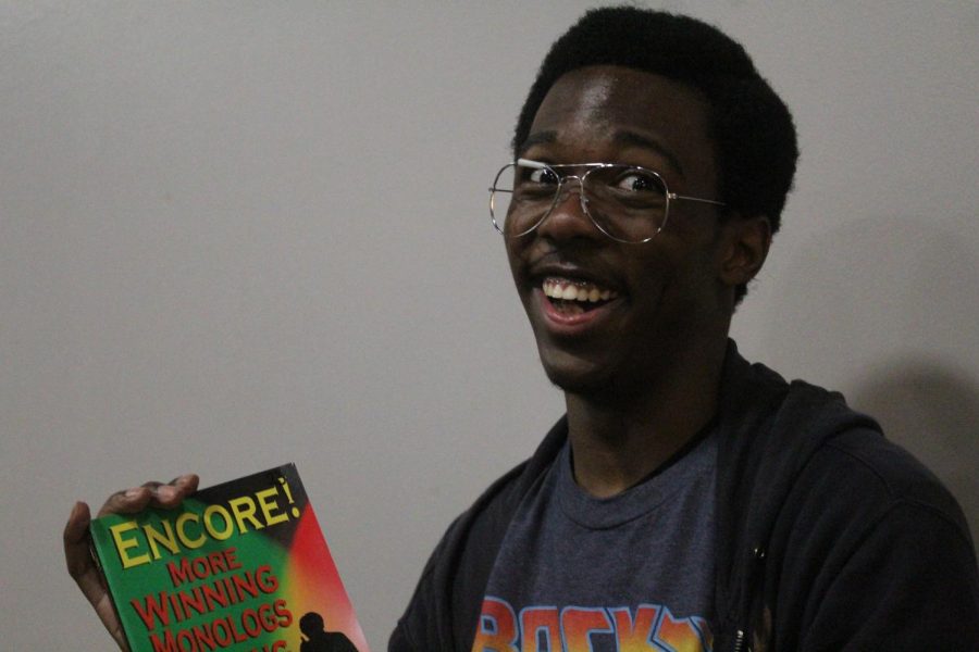 Nigel Bailey an aspiring playwright poses for photos while holding a book full of monologues on Sept. 28.
