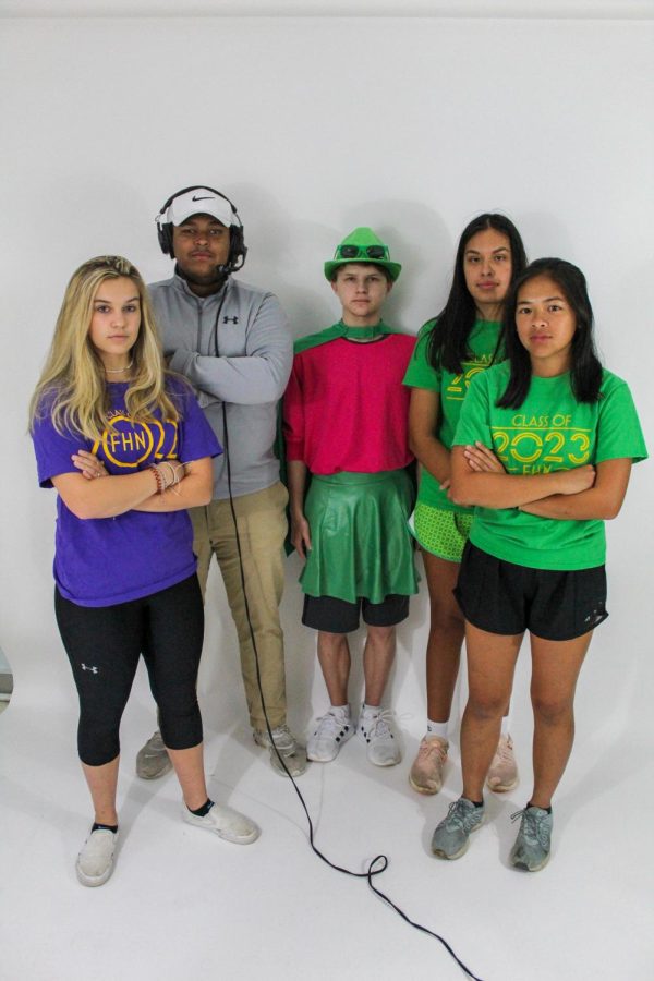 Seniors Grace Herbert, Gabe Kasper and juniors Parker Bruns, Amelia Churma, and Joshi Vargas pose in their PowderPuff attire. Hebert is competing, Kasper is a coach for the senior, Bruns is a crowd pleaser and Vargas and Chruma are competing.