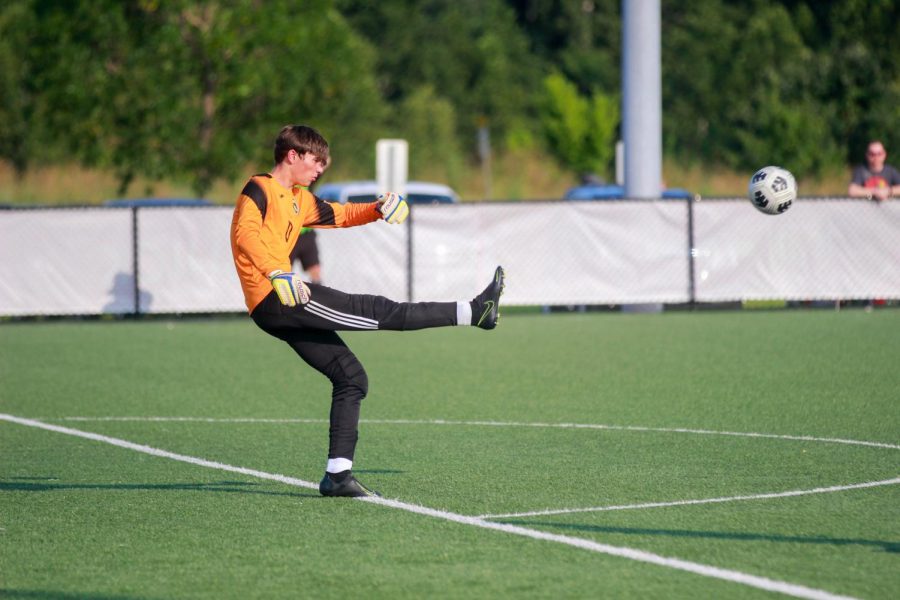 Senior Austin Bitter Kicks the Soccer Ball from the Goal Box