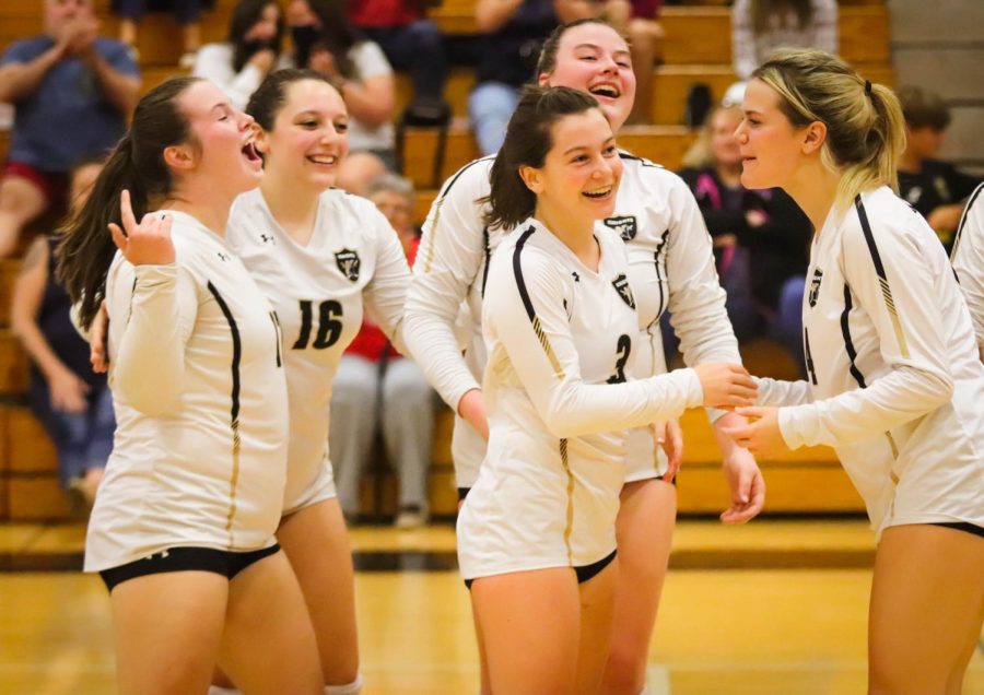 Seniors from the varsity volleyball team celebrate during their game.