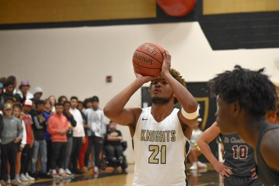 Senior Trenton Oglesby shoots a free throw in a game vs. St. Charles West on Nov. 19. Oglesby leads the team in rebounds, averaging 11 rebounds/game. He has played basketball most of his life, and has played all four of his years at FHN.