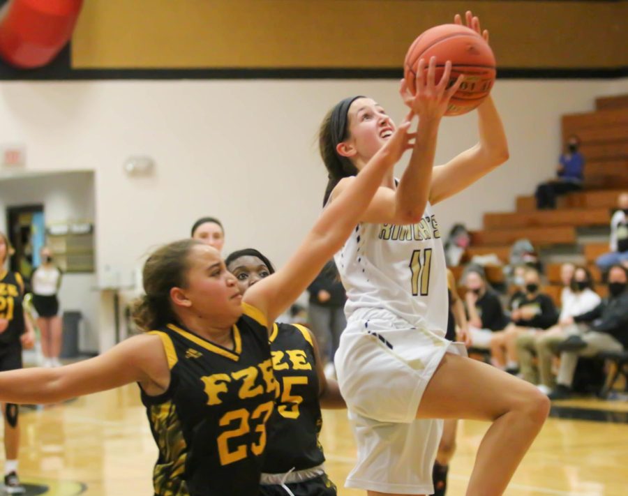 Hannah Ermeling jumps to shoot a layup. She was the second-highest scorer last year, and will likely lead the team in points this year since Isabelle Delarue, the team's lead scorer last year, graduated. 