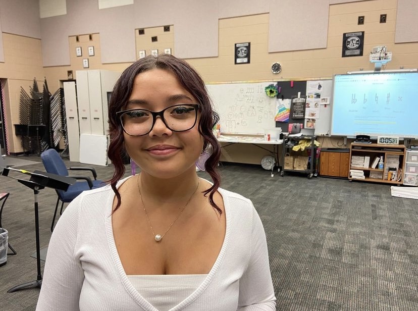 Sophomore Kaitlyn Shariff poses for a photo in the FHN choir room 